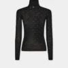 Turtleneck-top i uld, der sidder som et ekstra lag hud